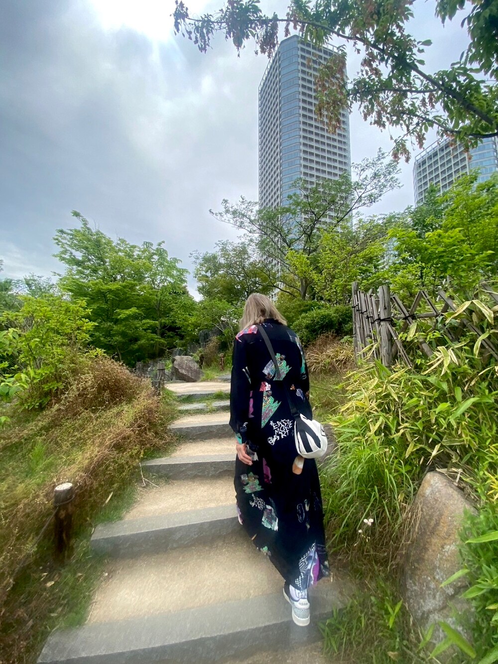 ブラック系のシャツワンピースを着用したレディースの春コーディネートの2枚目の写真