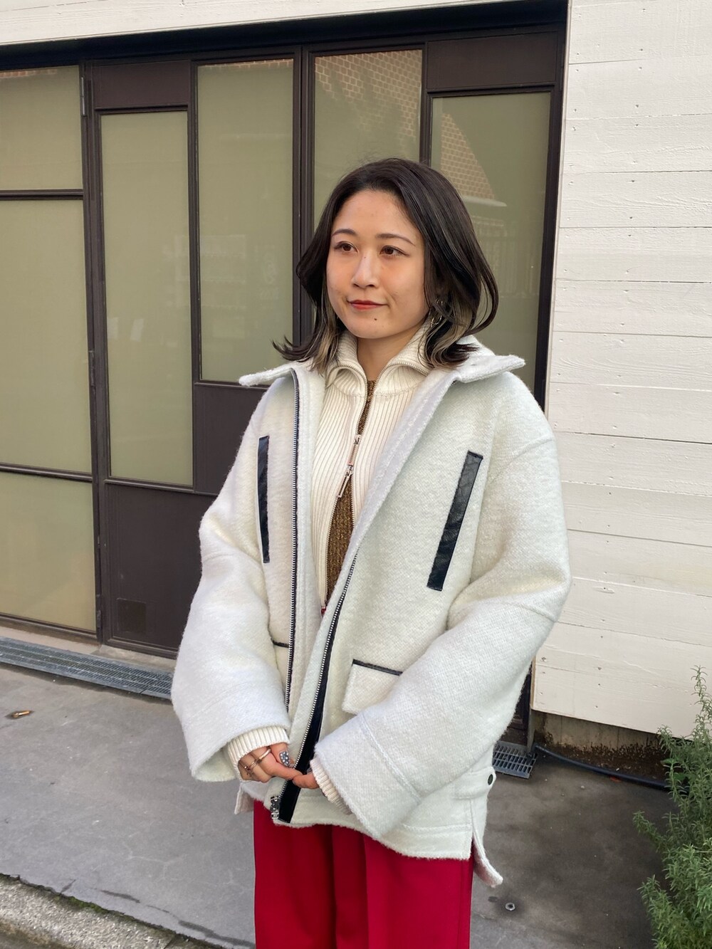 レッド系のその他パンツ、ホワイト系のニット/セーター、イエロー系のニット/セーターを着用したレディースの冬コーディネートの5枚目の写真