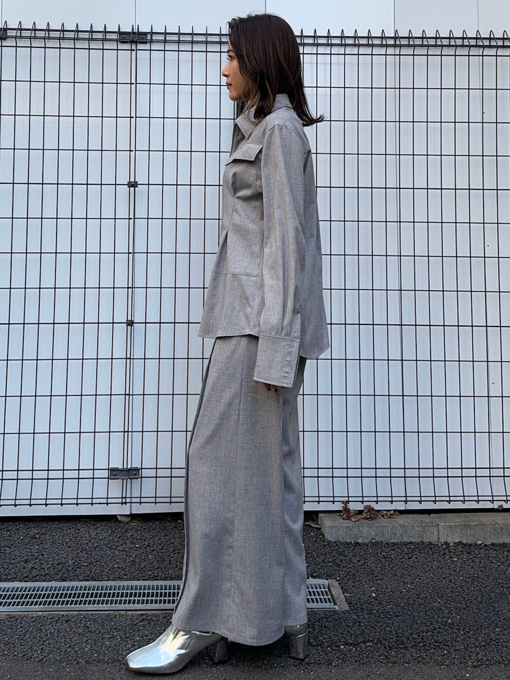 グレー系のシャツ/ブラウス、グレー系のスラックスを着用したレディースの冬コーディネートの4枚目の写真