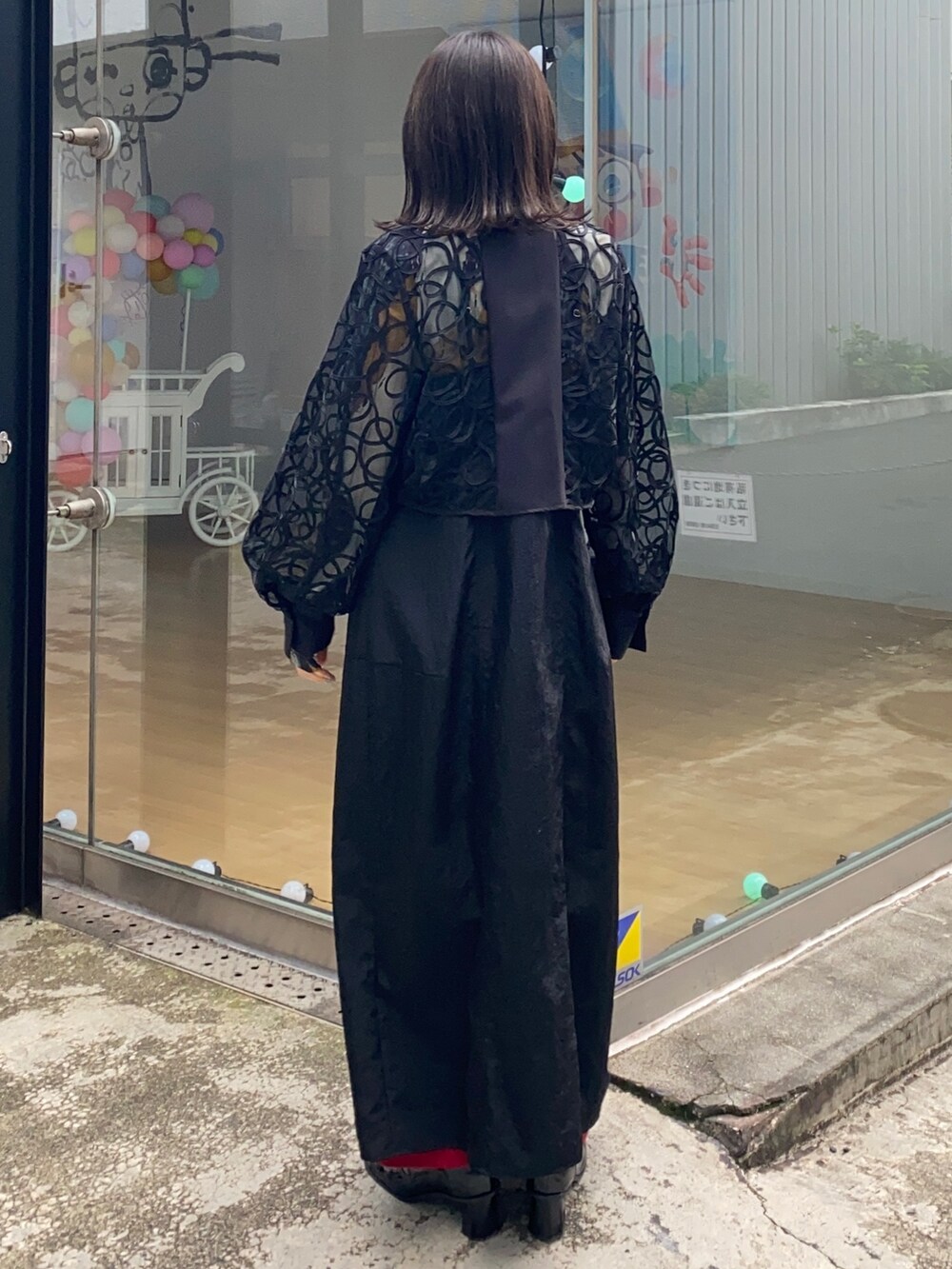 ブラック系のシャツ/ブラウス、ブラック系のジャンパースカート、レッド系のその他パンツを着用したレディースの冬コーディネートの3枚目の写真