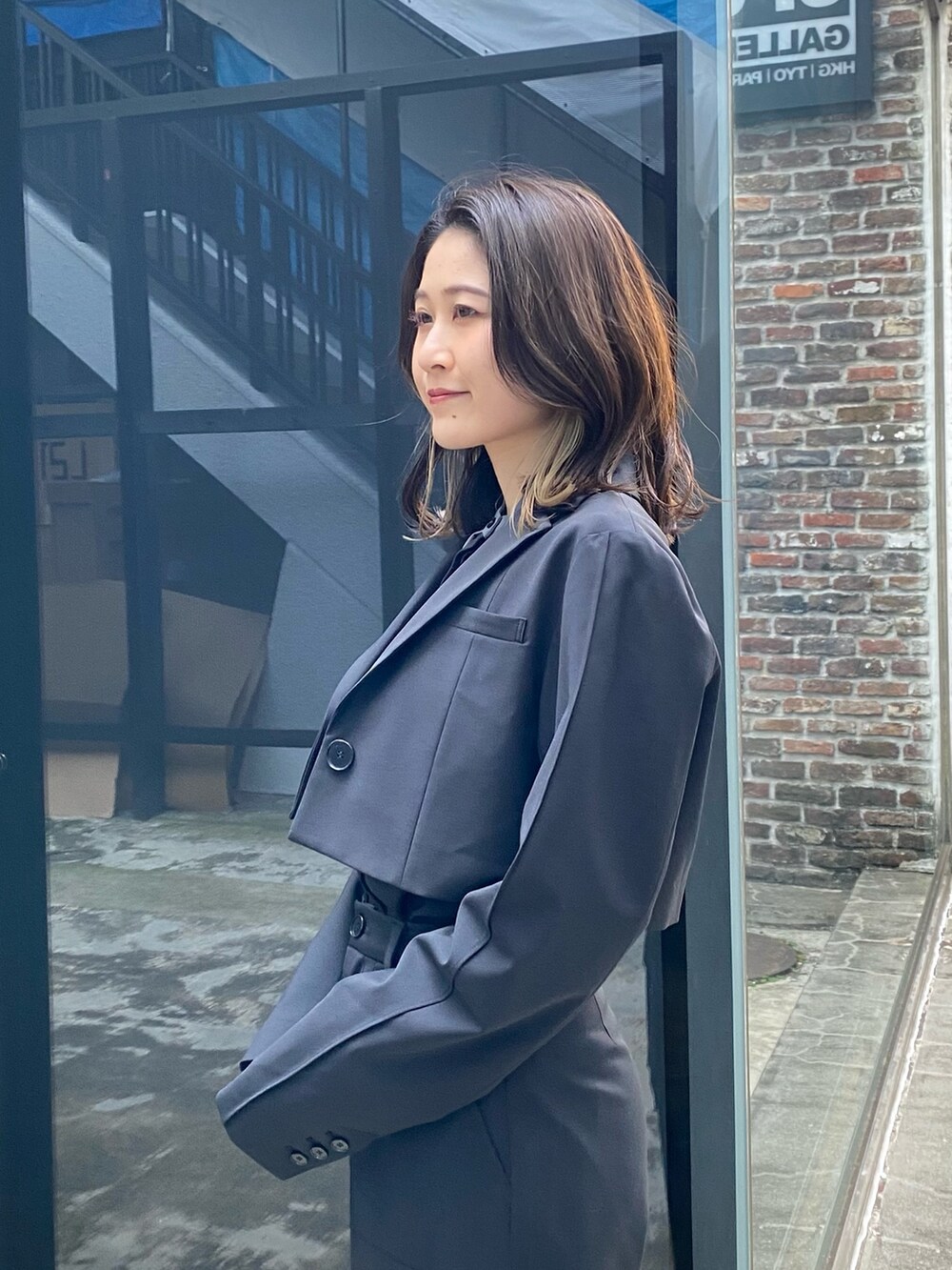 シルバー系のショルダーバッグ、ブラック系のシャツ/ブラウス、ブラック系のテーラードジャケットを着用したレディースの冬コーディネートの6枚目の写真