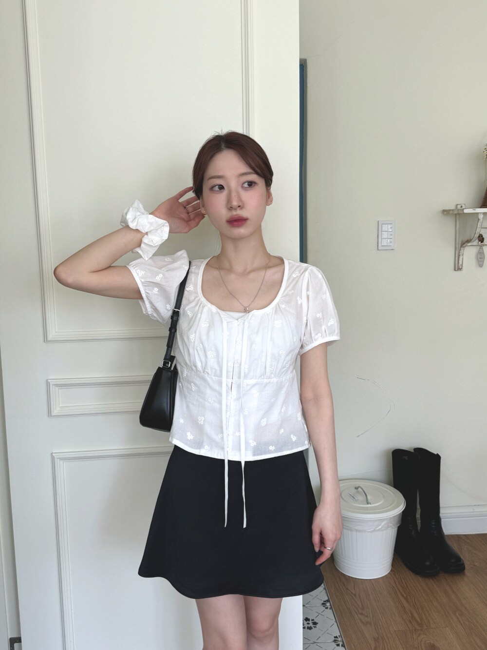 ホワイト系のシャツ/ブラウス、ブラック系のスカート、ブラック系のハンドバッグを着用したレディースの春コーディネートの2枚目の写真