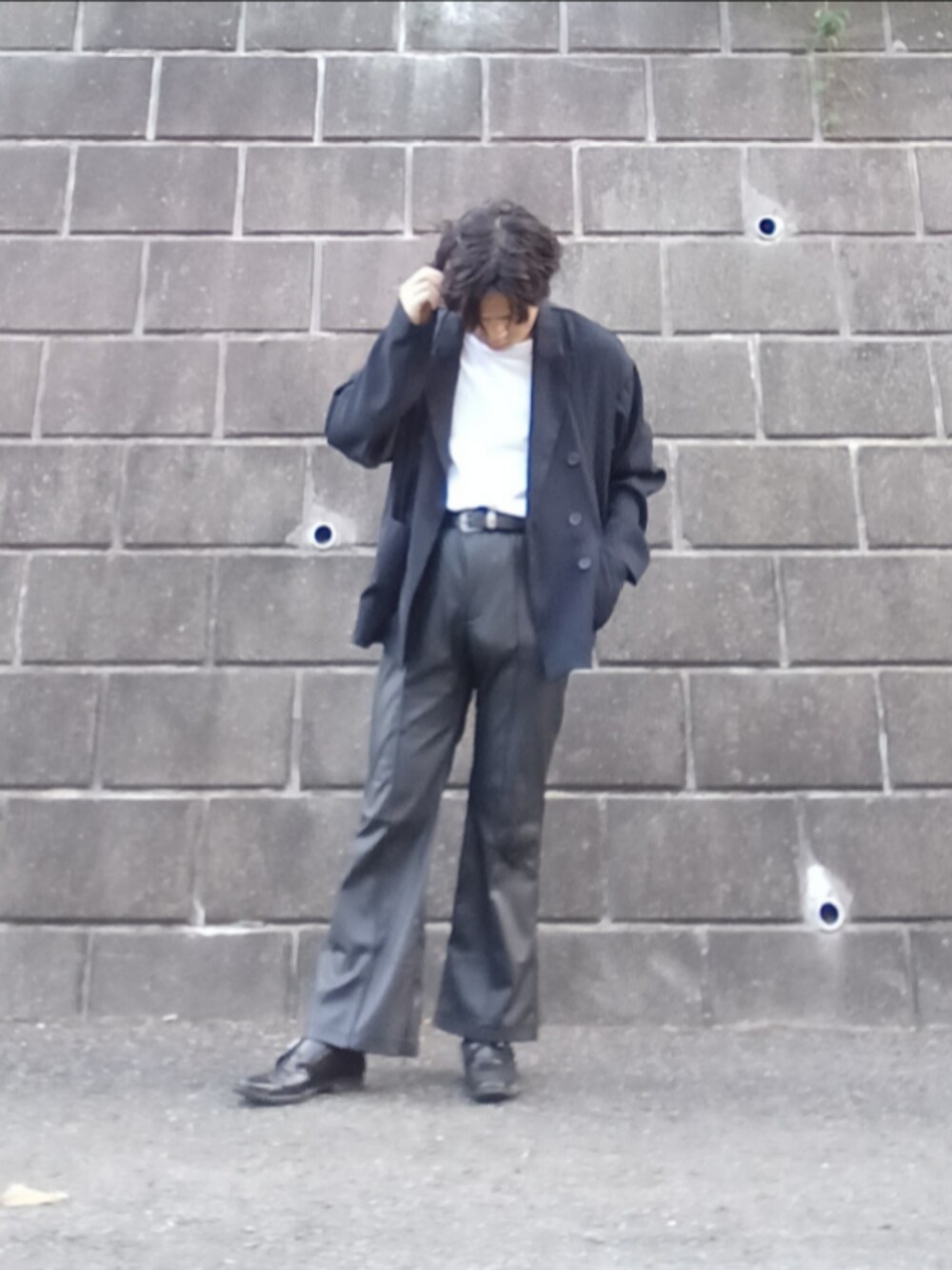 ブラック系のナイロンジャケット、グレー系のデニムパンツ、ブラック系のシューズを着用したメンズの夏コーディネートの2枚目の写真