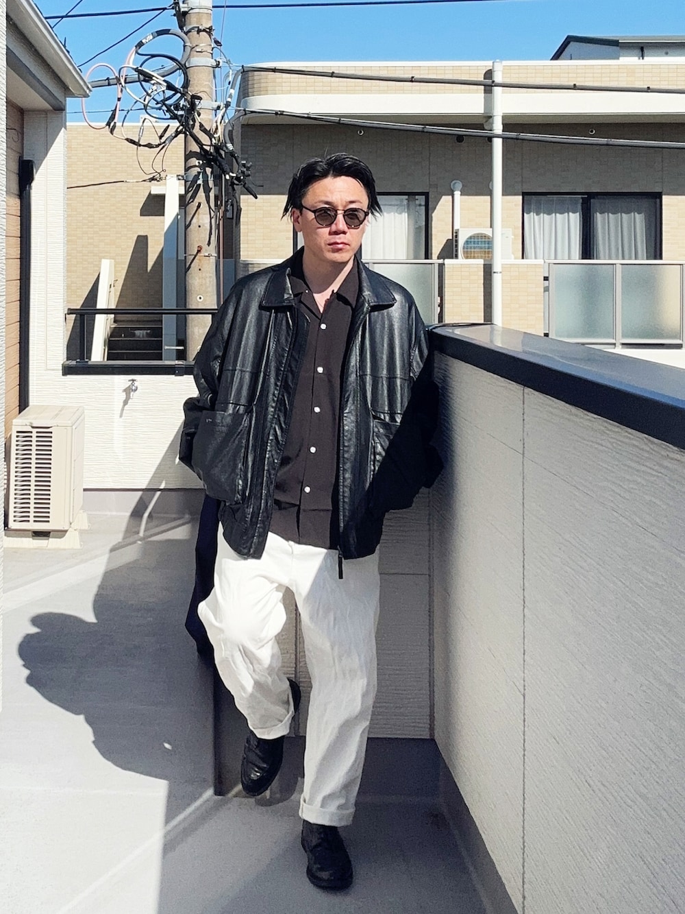 ブラック系のブルゾン、ホワイト系のデニムパンツ、ブラック系のシャツ/ブラウスを着用したメンズの春コーディネートの4枚目の写真