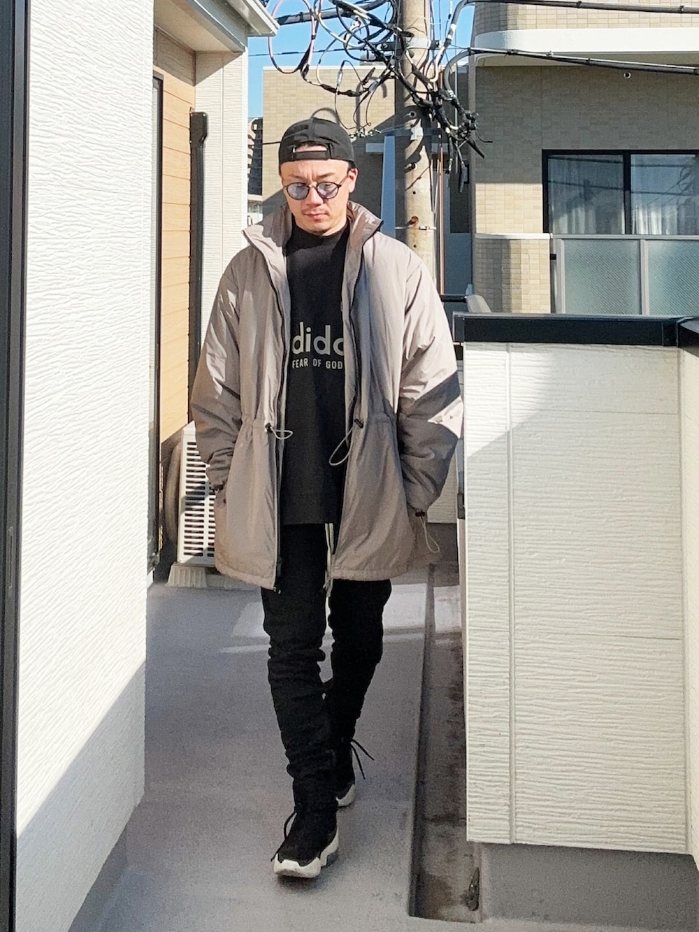 ブラック系のスウェット、ベージュ系のその他アウター、ブラック系のパンツを着用したメンズの冬コーディネートの2枚目の写真