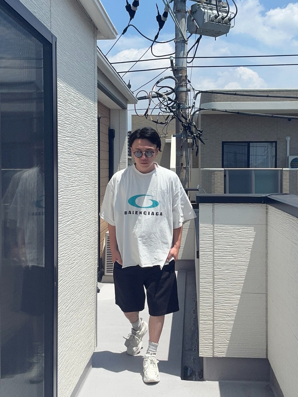 ホワイト系のTシャツ/カットソー、ブラック系のスウェットパンツ、ホワイト系のスニーカーを着用したメンズの夏コーディネートの2枚目の写真