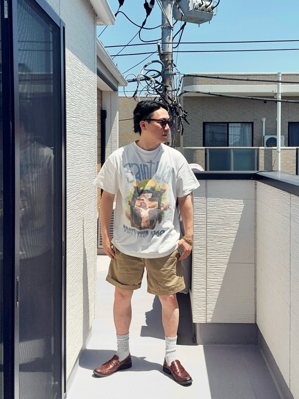 ホワイト系のTシャツ/カットソー、ベージュ系のパンツ、ブラウン系のローファーを着用したメンズの春コーディネートの2枚目の写真