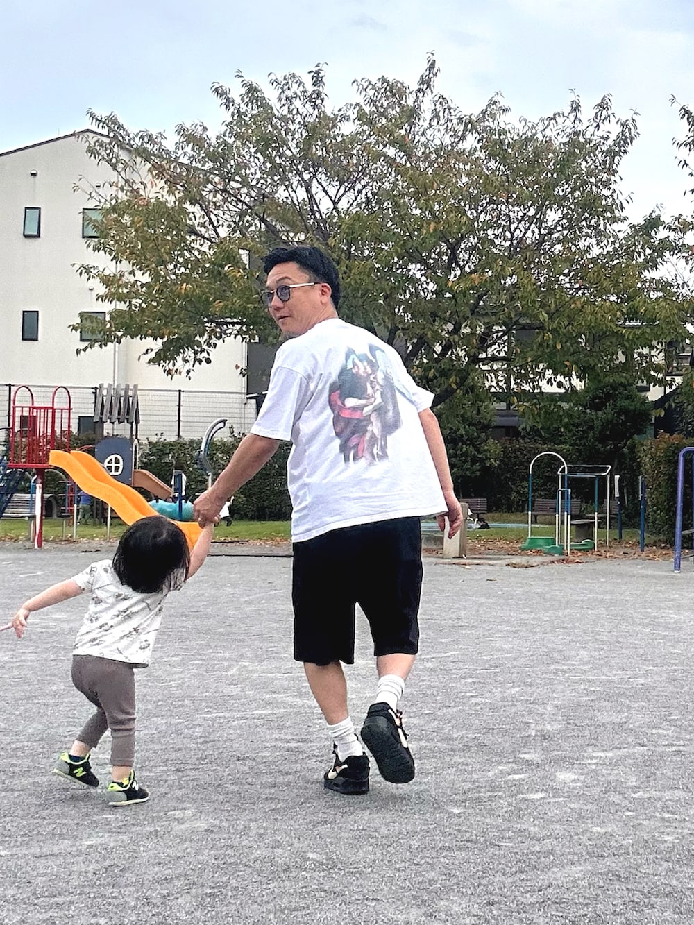 ブラック系のスニーカー、ホワイト系のTシャツ/カットソー、ブラック系のスウェットパンツを着用したメンズの秋コーディネートの3枚目の写真