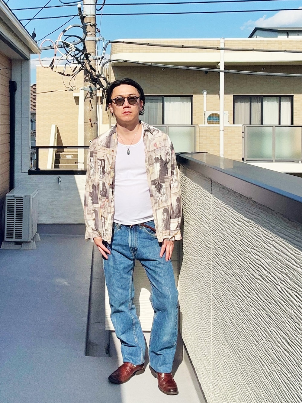ブルー系のデニムパンツ、ホワイト系のタンクトップ、ベージュ系のシャツ/ブラウスを着用したメンズの春コーディネートの3枚目の写真
