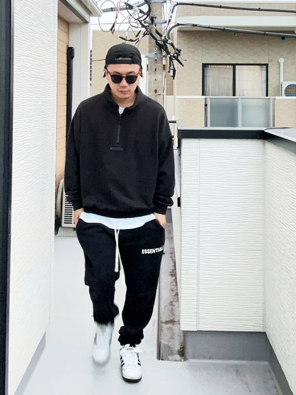 ブラック系のスウェット、ホワイト系のTシャツ/カットソー、ブラック系のスウェットパンツを着用したメンズの秋コーディネートの2枚目の写真