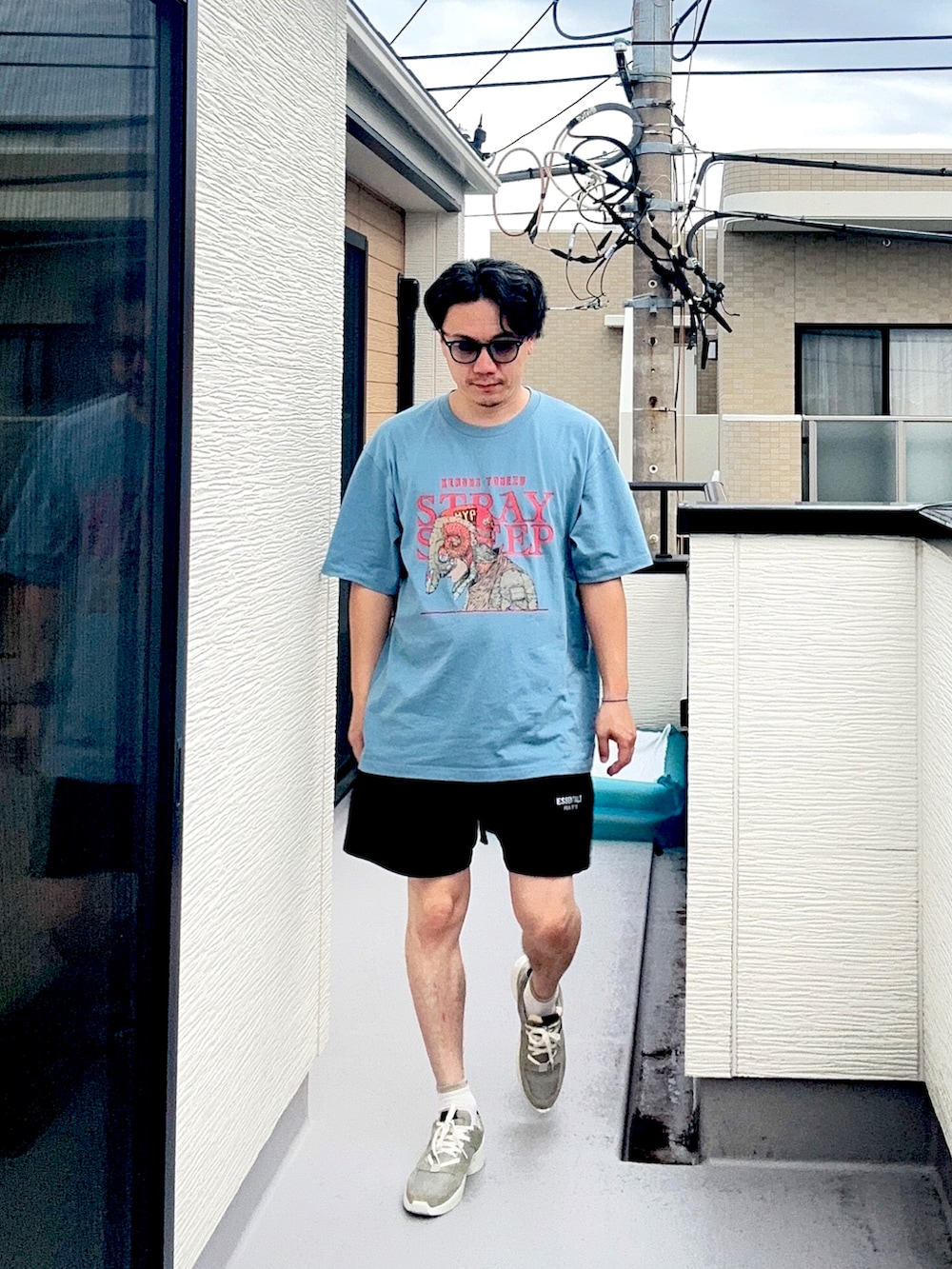 ブルー系のTシャツ/カットソー、ブラック系のスウェットパンツ、グレー系のスニーカーを着用したメンズの秋コーディネートの3枚目の写真
