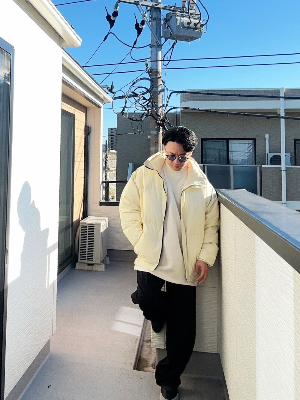 ベージュ系のダウンジャケット/コート、ブラック系のスラックス、ブラック系のスニーカーを着用したメンズの冬コーディネートの2枚目の写真