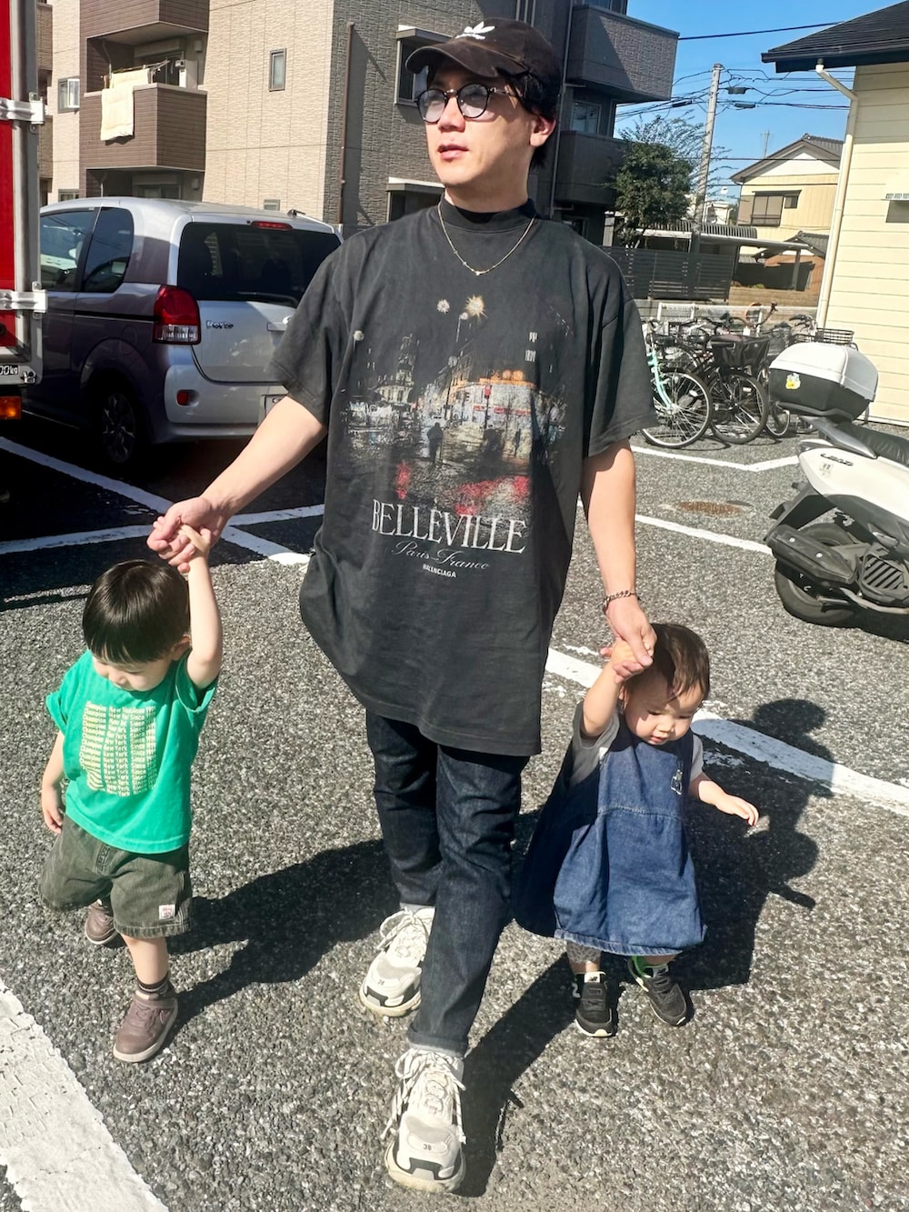 ブラック系のTシャツ/カットソー、ブルー系のデニムパンツ、ホワイト系のシューズを着用したメンズの秋コーディネートの2枚目の写真