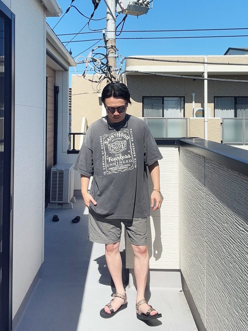 ブラック系のTシャツ/カットソー、ブラック系のパンツ、その他のサンダルを着用したメンズの夏コーディネートの2枚目の写真