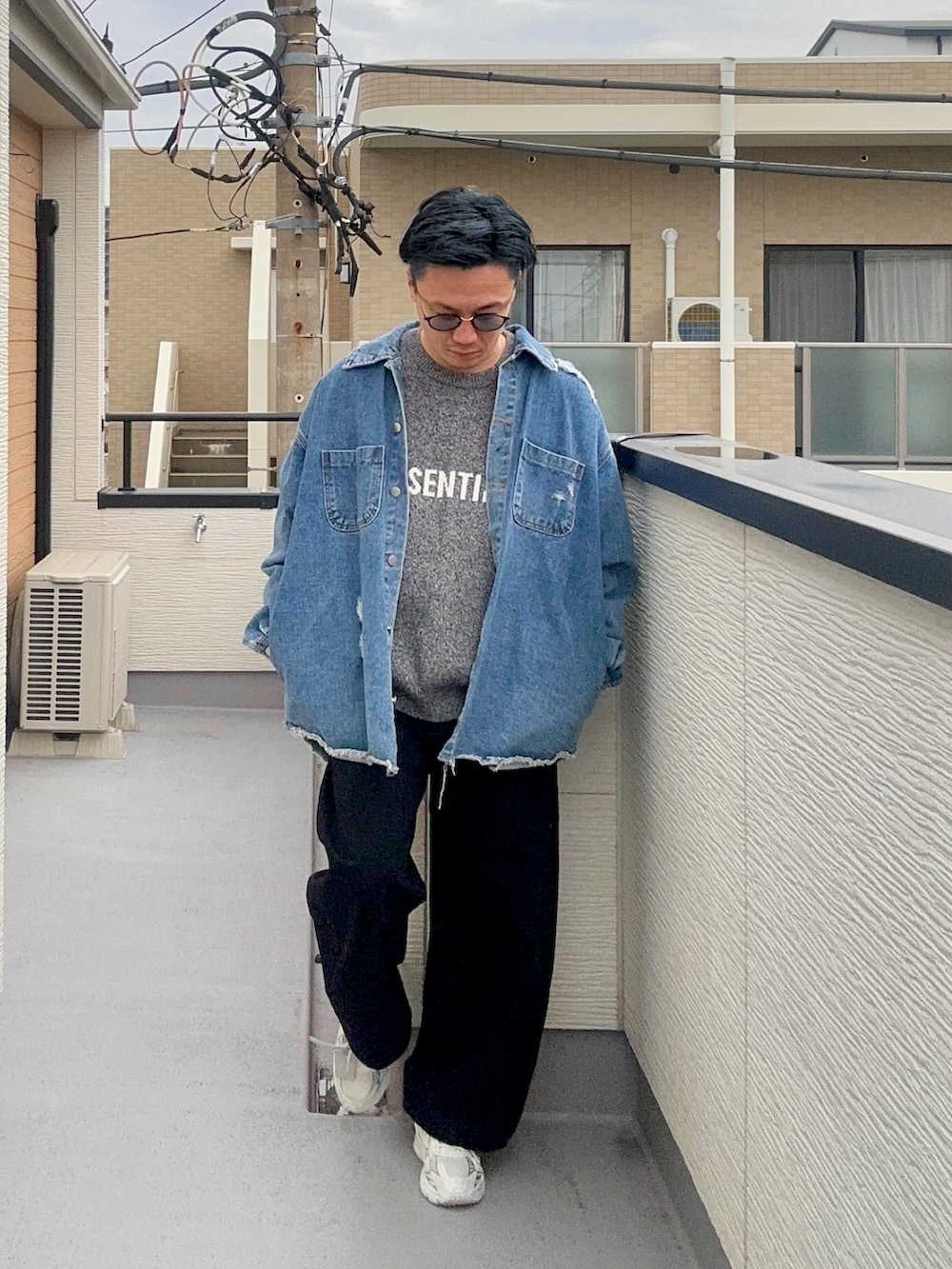 グレー系のニット/セーター、ブルー系のデニムジャケット、ブラック系のパンツを着用したメンズの冬コーディネートの3枚目の写真