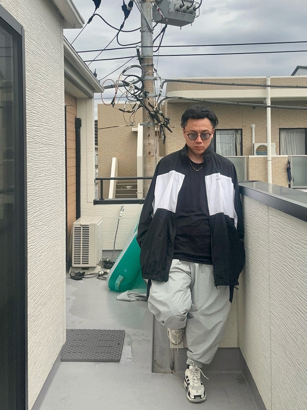 グレー系のその他パンツ、ブラック系のTシャツ/カットソー、ブラック系のナイロンジャケットを着用したメンズの秋コーディネートの4枚目の写真