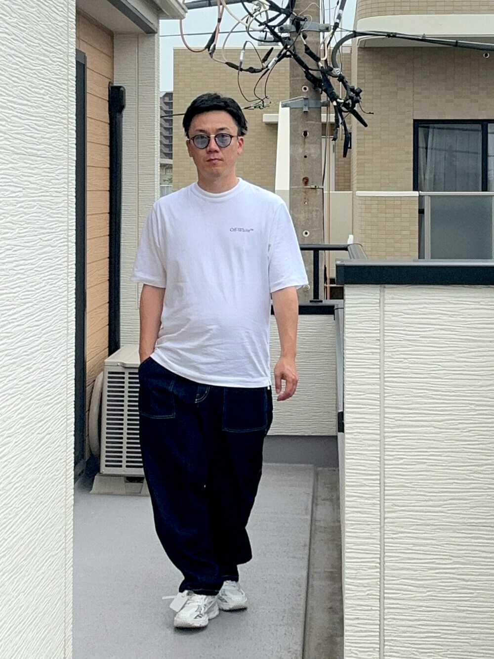 ホワイト系のTシャツ/カットソー、ブルー系のデニムパンツ、ホワイト系のスニーカーを着用したメンズの夏コーディネートの2枚目の写真