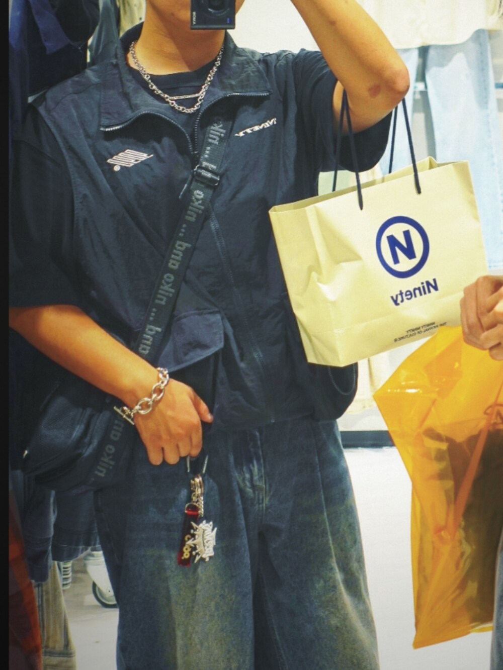 ブラック系のTシャツ/カットソー、ブルー系のデニムパンツ、ブラック系のスニーカーを着用したメンズの夏コーディネートの3枚目の写真