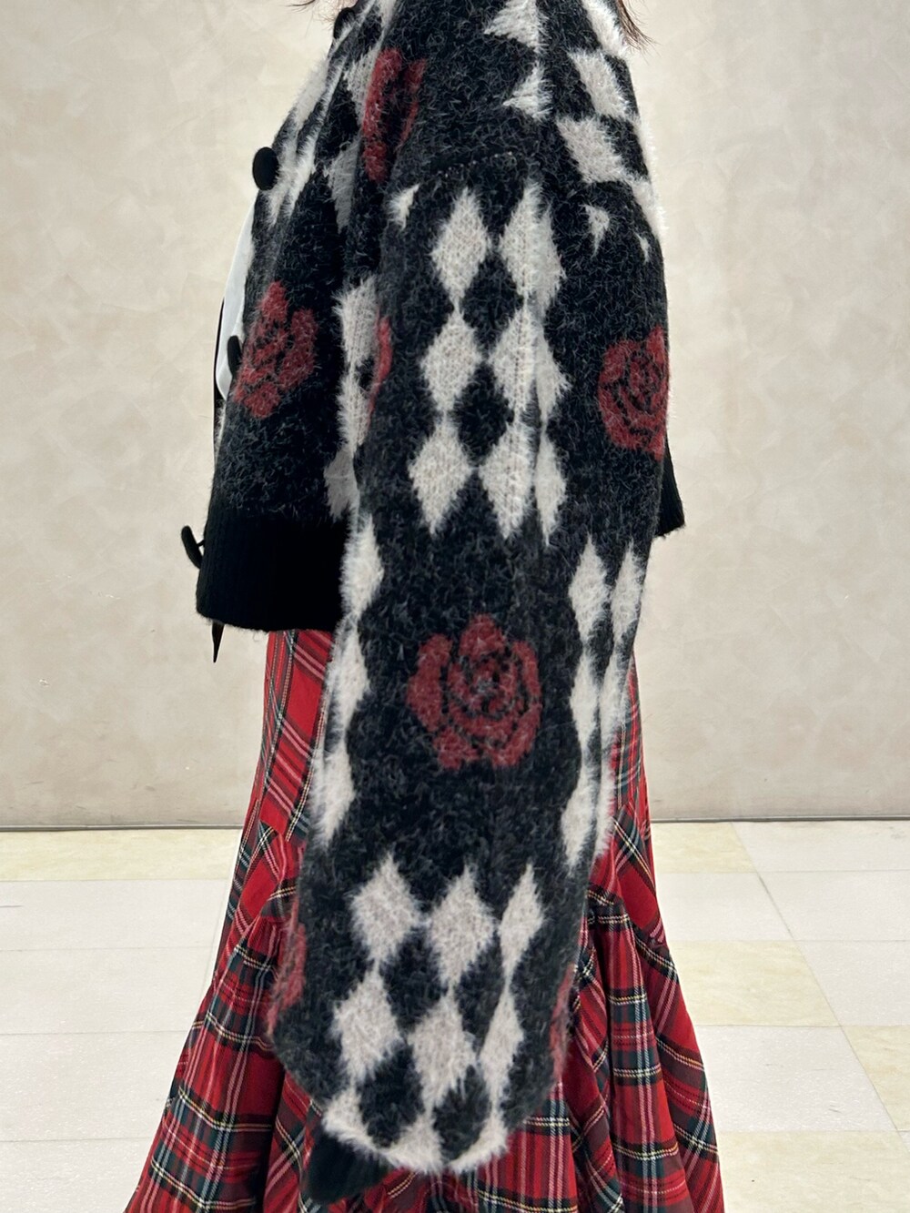 レッド系のスカート、ブラック系のドレスシューズ、ブラック系のカーディガン/ボレロを着用したレディースの秋コーディネートの7枚目の写真