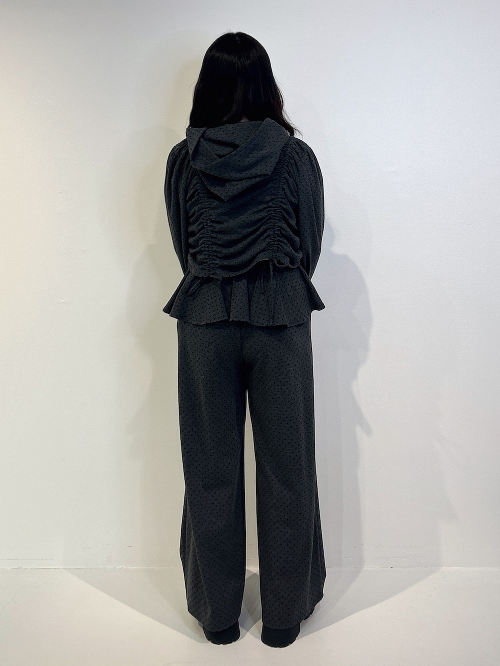 グレー系のスウェットパンツ、ブラック系のパーカー、ブラック系のローファーを着用したレディースの冬コーディネートの3枚目の写真