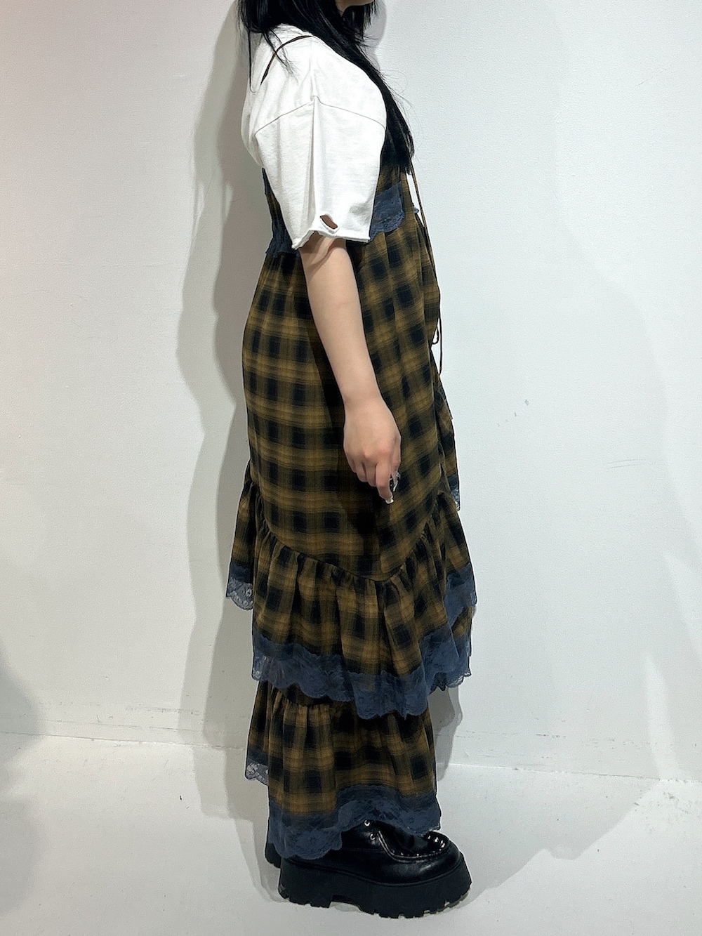 イエロー系のワンピース、ホワイト系のTシャツ/カットソー、ブラック系のローファーを着用したレディースの春コーディネートの2枚目の写真