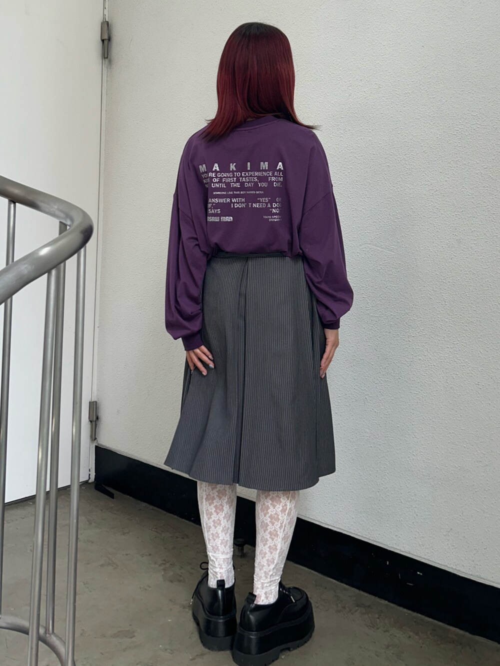 グレー系のスカート、ブラック系のドレスシューズ、パープル系のTシャツ/カットソーを着用したレディースの夏コーディネートの3枚目の写真