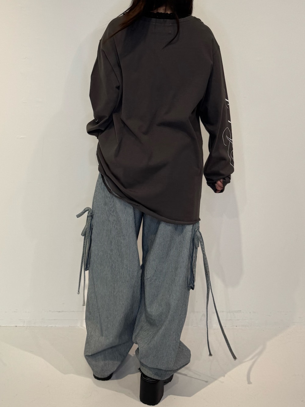 ブラック系のTシャツ/カットソー、ブラック系のデニムパンツ、ブラウン系のメガネを着用したレディースの春コーディネートの3枚目の写真