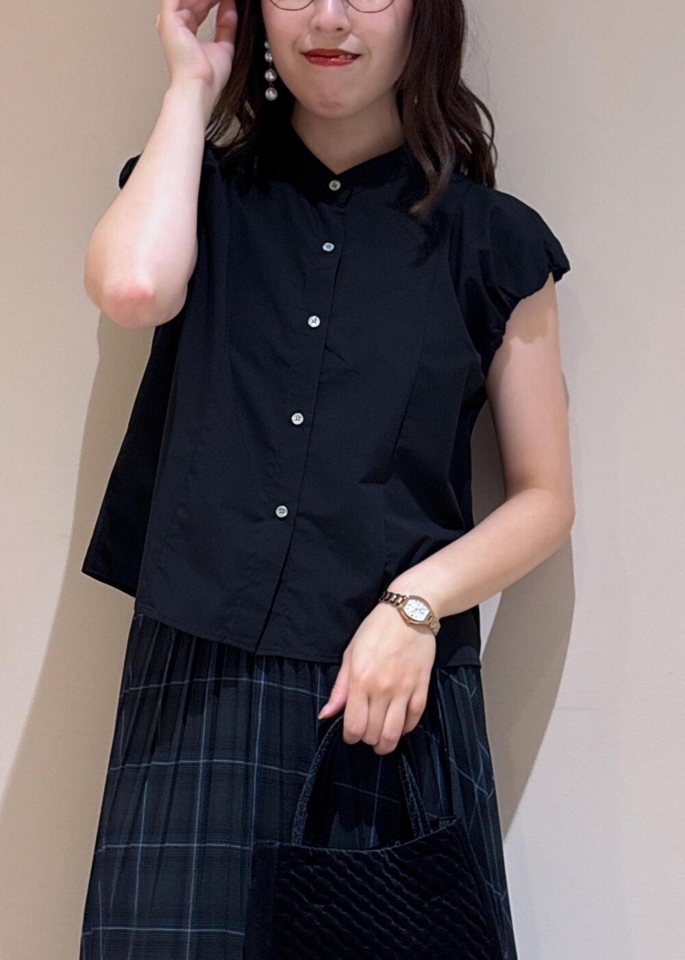 グリーン系のスカート、ブラック系のシャツ/ブラウス、シルバー系のローファーを着用したレディースの夏コーディネートの4枚目の写真