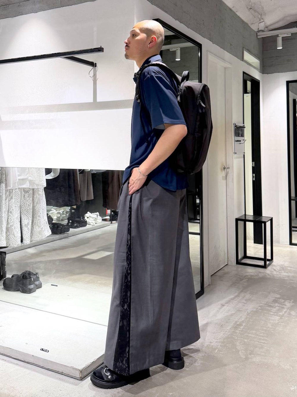 グレー系のその他パンツ、ブラック系のバックパック/リュック、ブラック系のサンダルを着用したメンズの夏コーディネートの2枚目の写真
