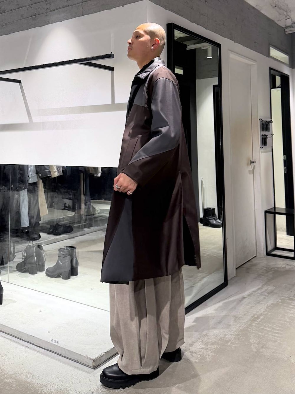 ブラック系のドレスシューズ、ブラック系のハンドバッグ、ブラック系のカーディガン/ボレロを着用したメンズの冬コーディネートの2枚目の写真