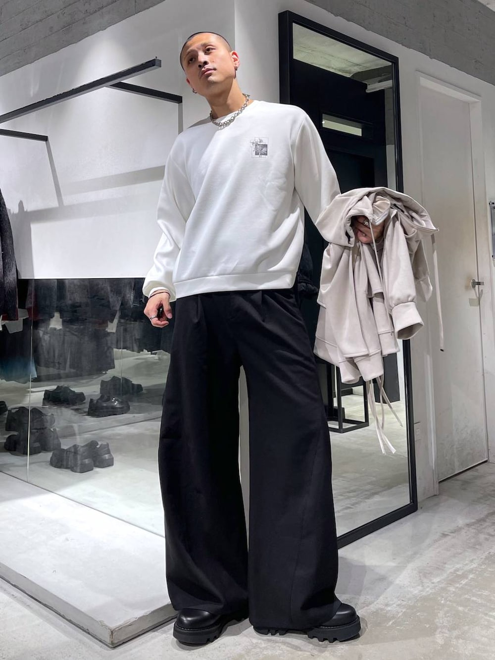 ブラック系のスラックス、ブラック系のショルダーバッグ、ブラック系のドレスシューズを着用したメンズの冬コーディネートの5枚目の写真