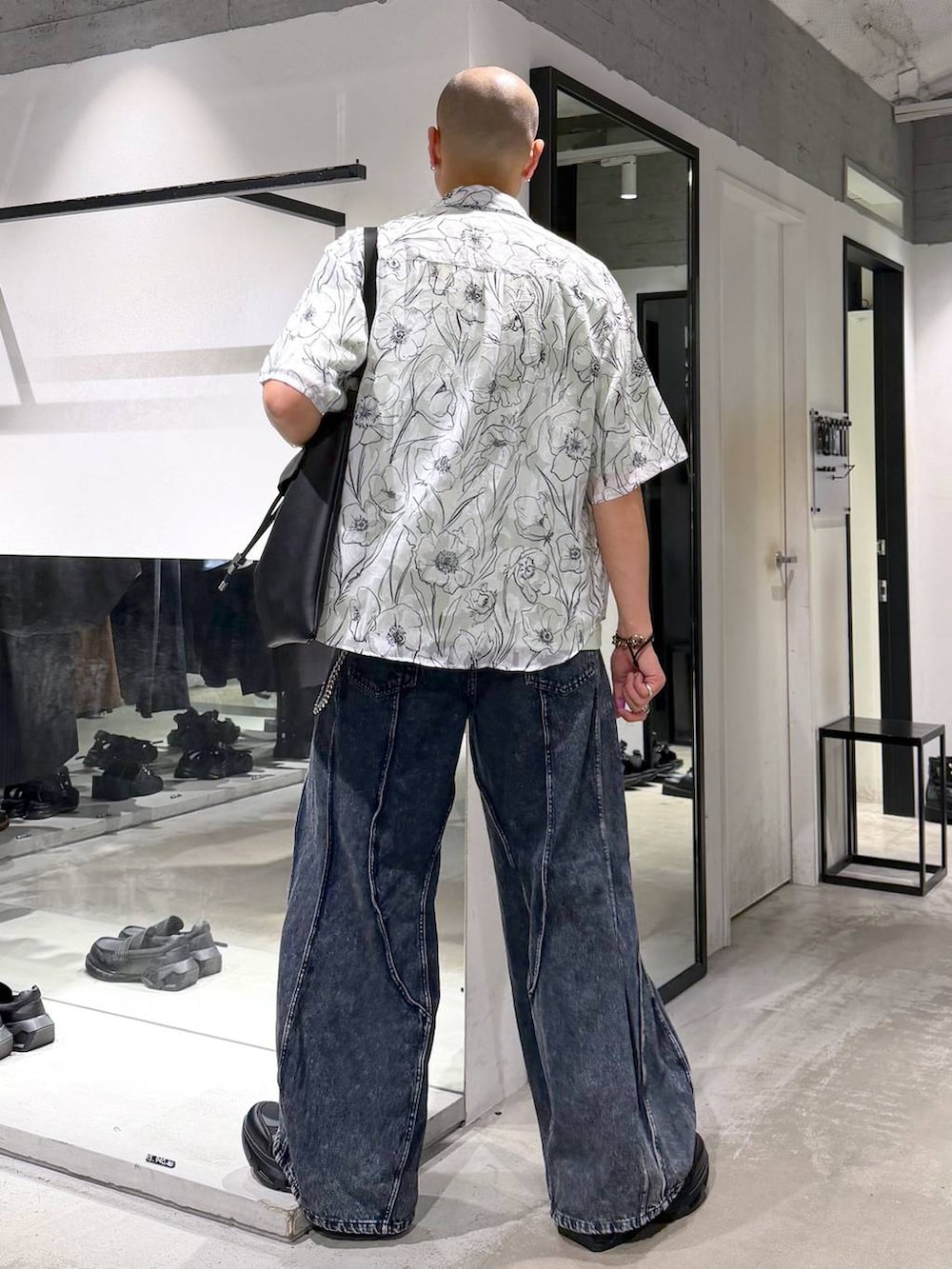 ブラック系のスニーカー、ブルー系のデニムパンツ、グリーン系のTシャツ/カットソーを着用したメンズの夏コーディネートの3枚目の写真