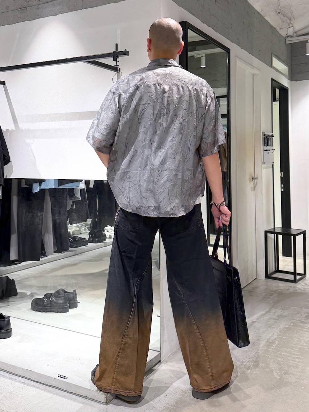 オレンジ系のデニムパンツ、ホワイト系のTシャツ/カットソー、ブラック系のサンダルを着用したメンズの夏コーディネートの3枚目の写真