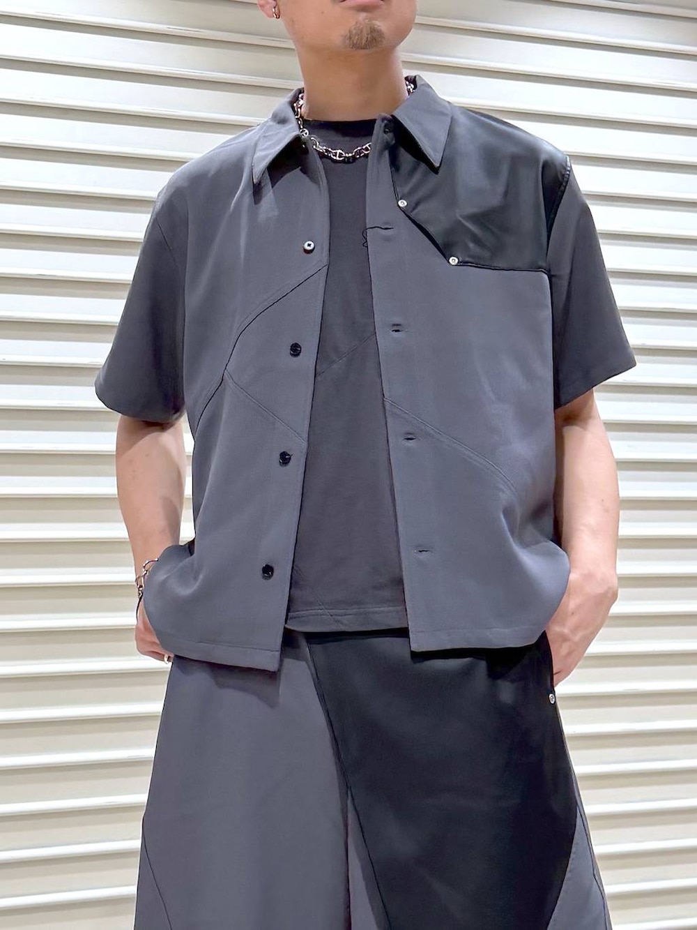 ブラック系のスニーカー、シルバー系のネックレスを着用したメンズの夏コーディネートの5枚目の写真