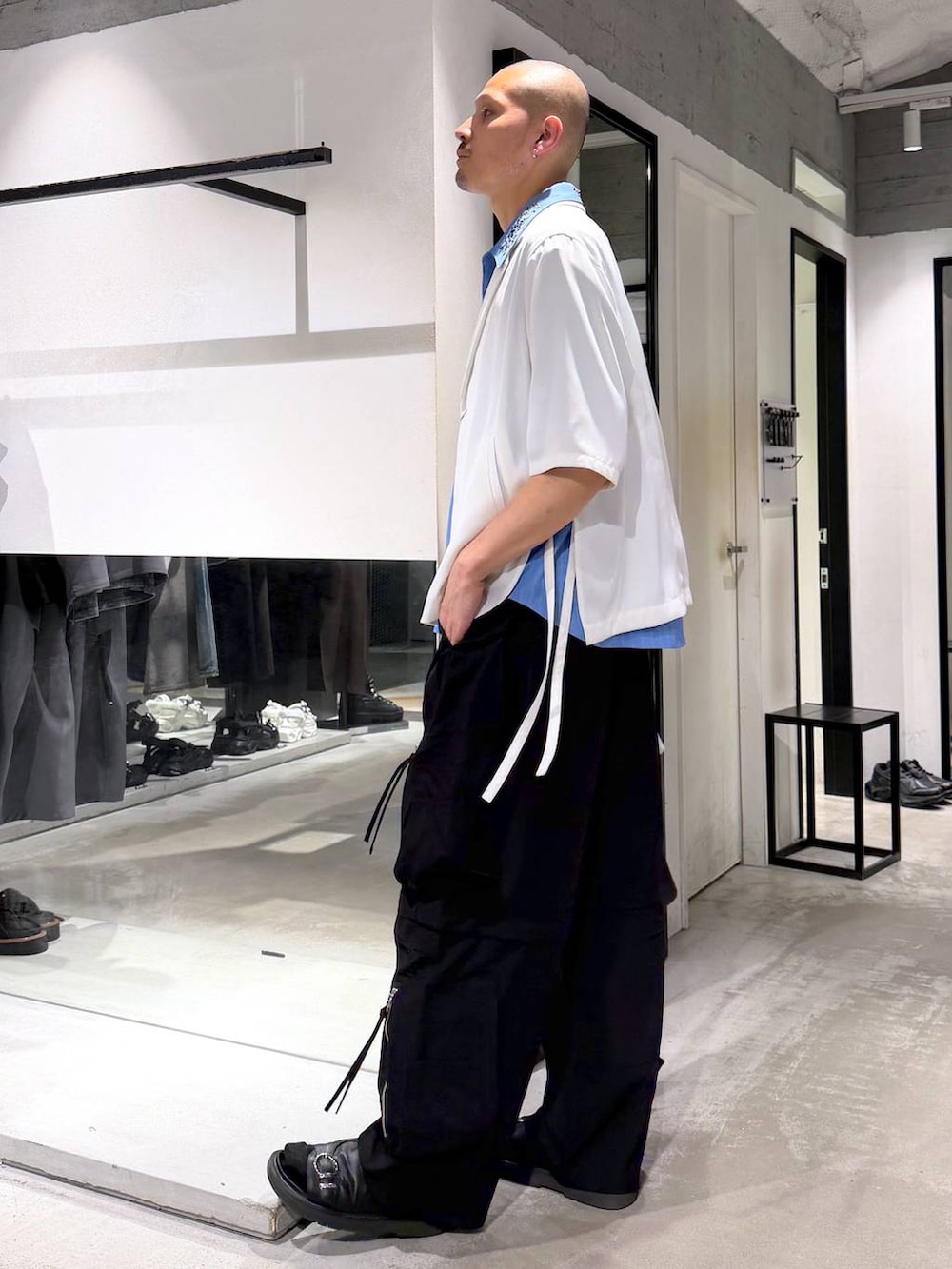 ブルー系のシャツ/ブラウス、ブラック系のトートバッグ、ブラック系のサンダルを着用したメンズの夏コーディネートの2枚目の写真