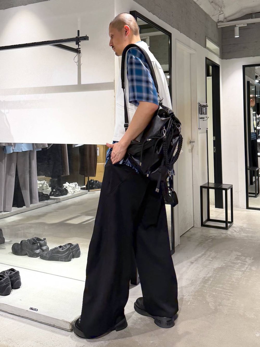 ブラック系のスラックス、ブルー系のシャツ/ブラウス、ブラック系のショルダーバッグを着用したメンズの夏コーディネートの2枚目の写真