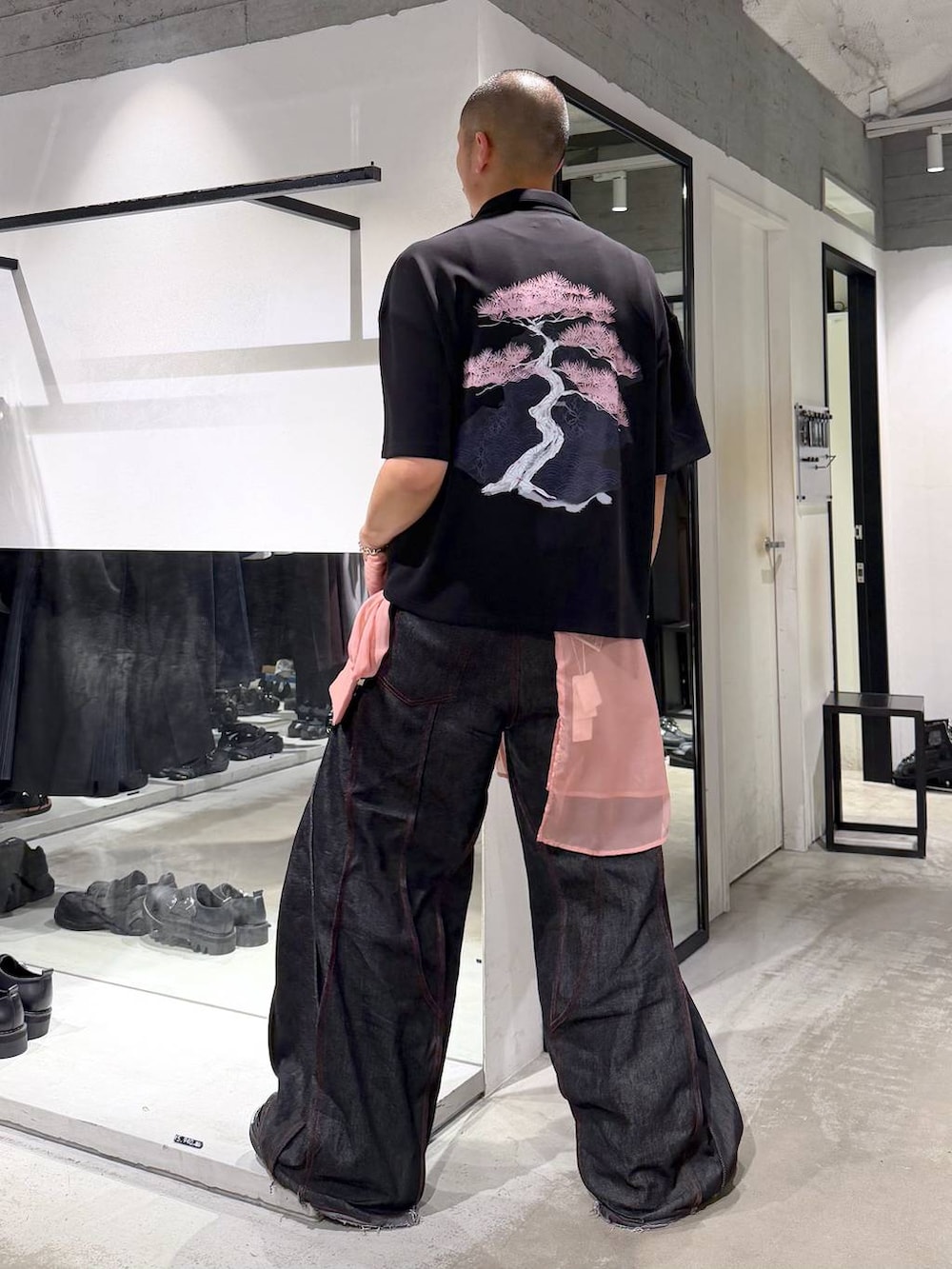ブラック系のTシャツ/カットソー、ブラック系のデニムパンツ、ブラック系のサンダルを着用したメンズの夏コーディネートの2枚目の写真