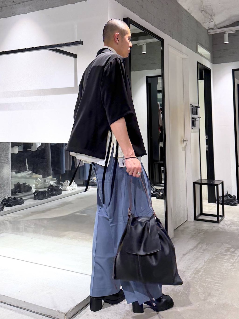 ホワイト系のシャツ/ブラウス、ブラック系のサンダル、ブルー系のスラックスを着用したメンズの春コーディネートの4枚目の写真