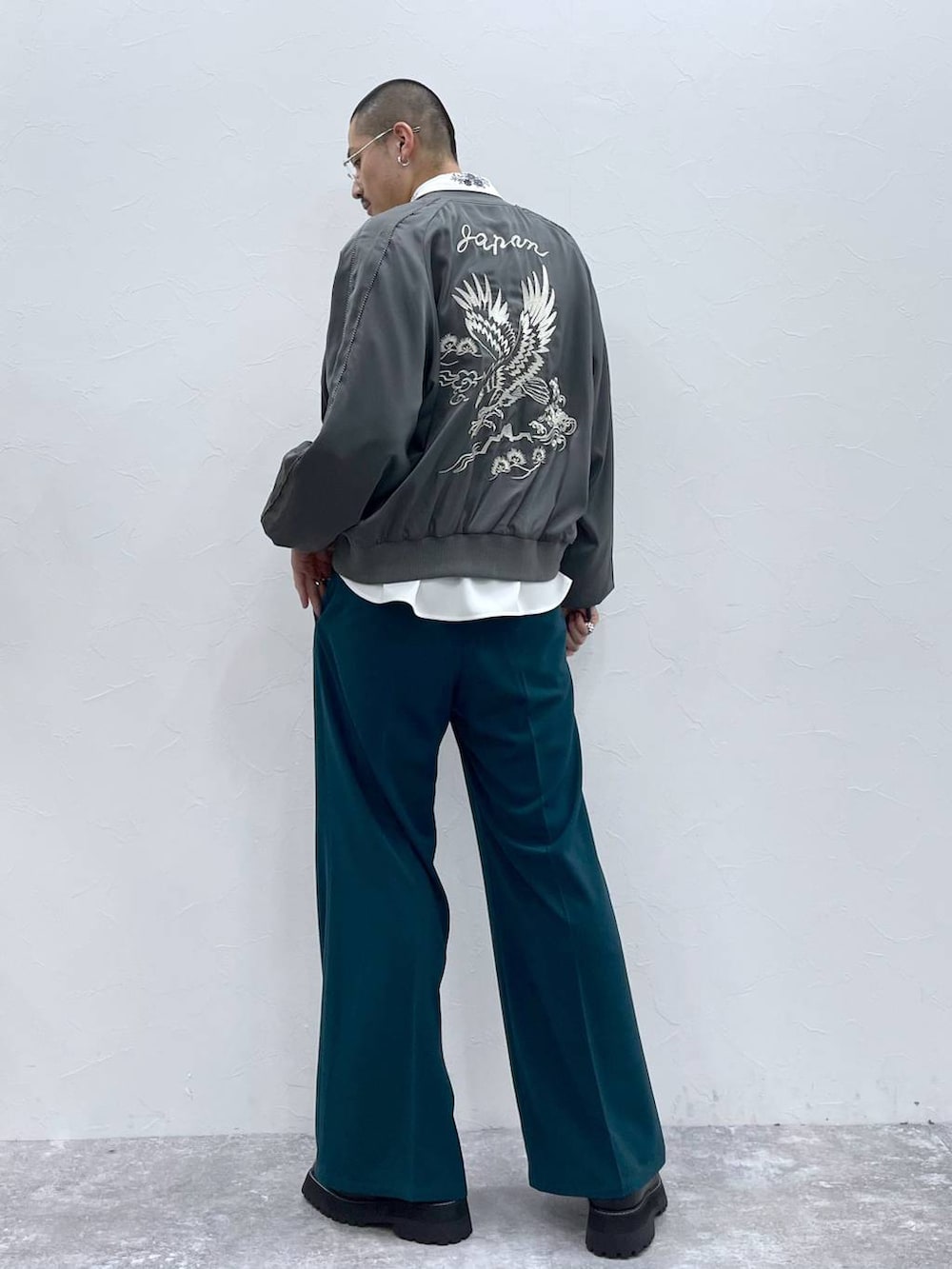 ホワイト系のシャツ/ブラウス、グレー系のスカジャン、グリーン系のスラックスを着用したメンズの秋コーディネートの2枚目の写真