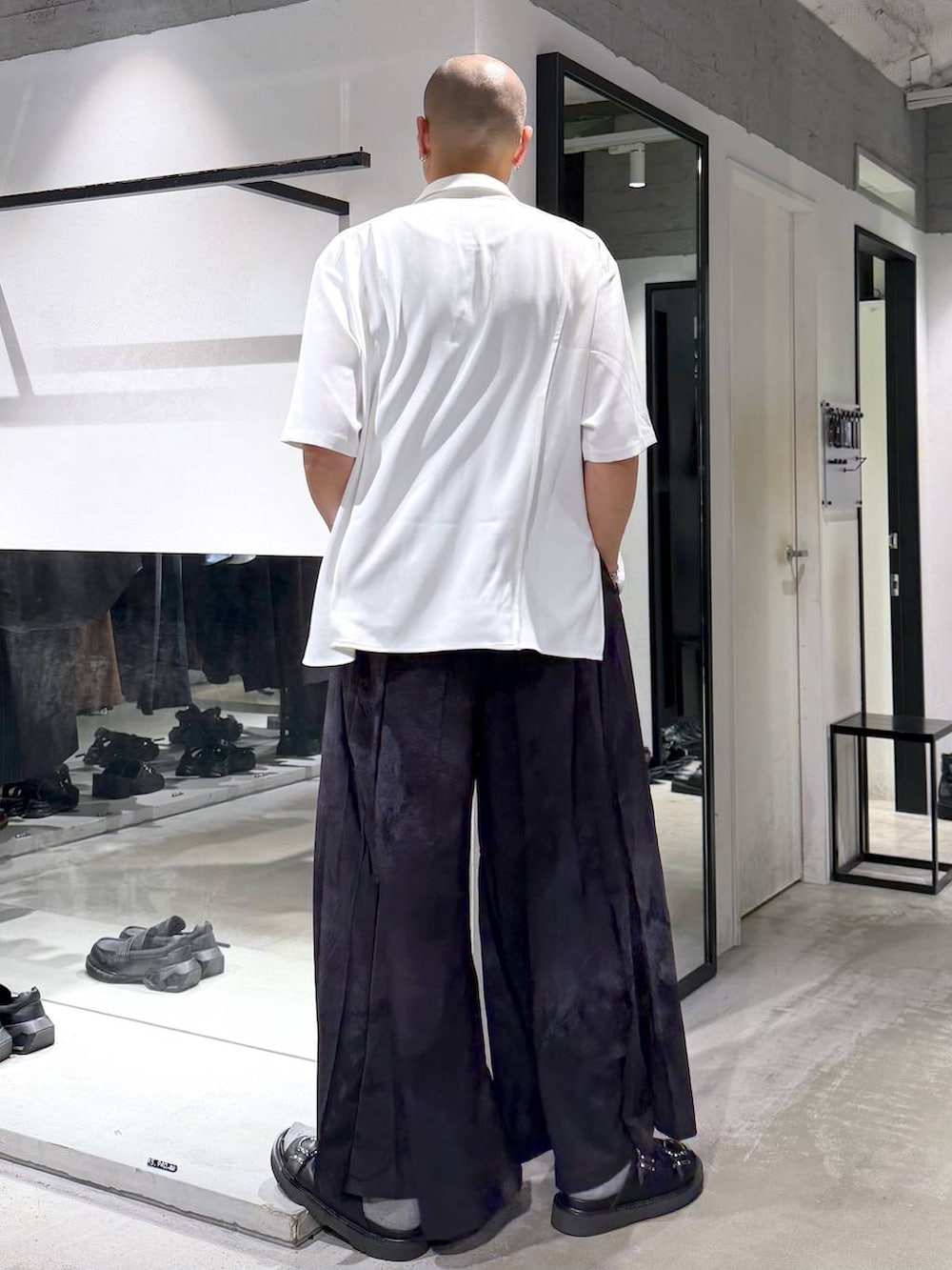 ホワイト系のシャツ/ブラウス、ブラック系のサンダル、グレー系のスラックスを着用したメンズの夏コーディネートの3枚目の写真