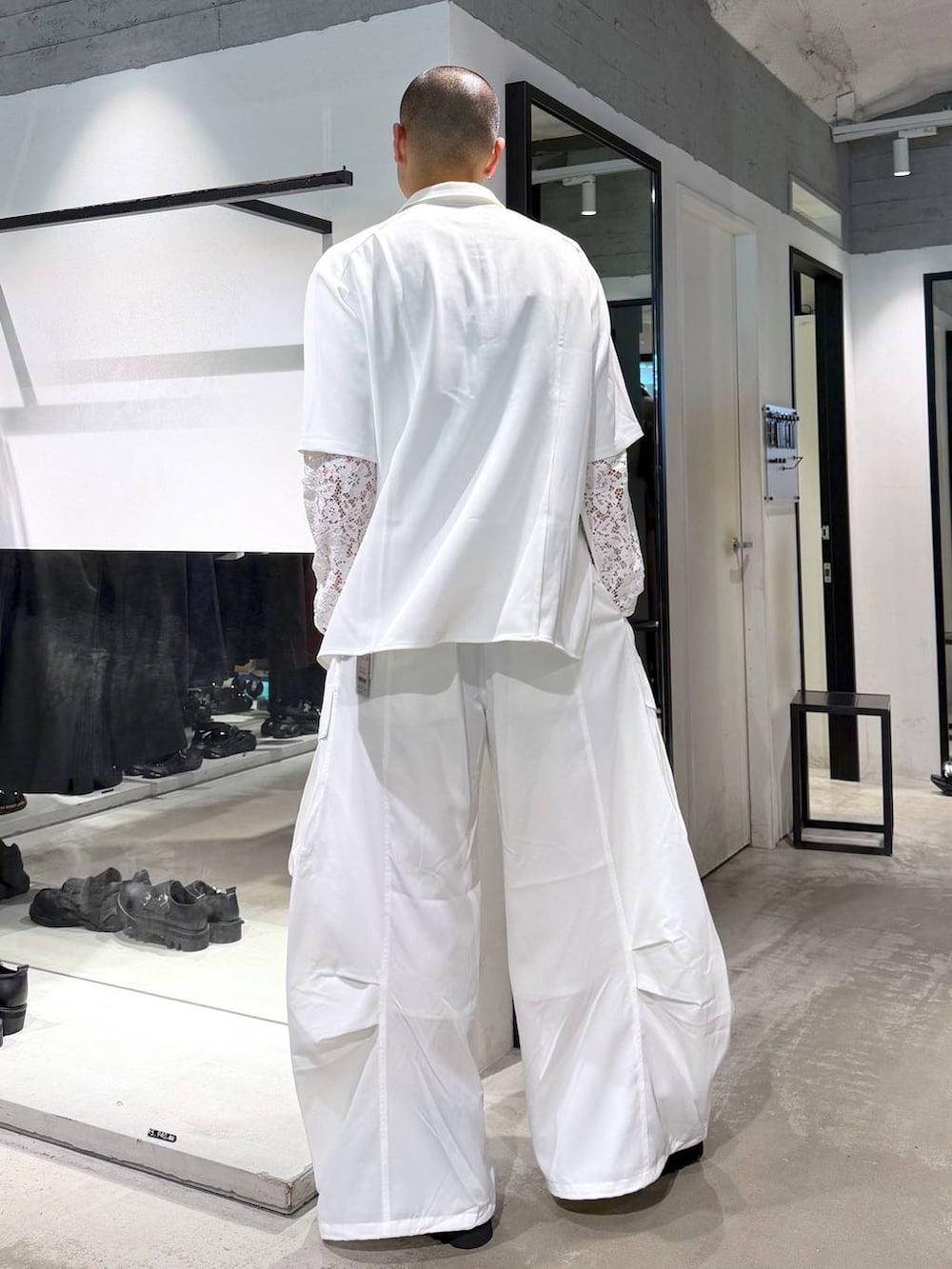 ホワイト系のシャツ/ブラウス、ホワイト系のカーゴパンツ、ブラック系のサンダルを着用したメンズの夏コーディネートの3枚目の写真