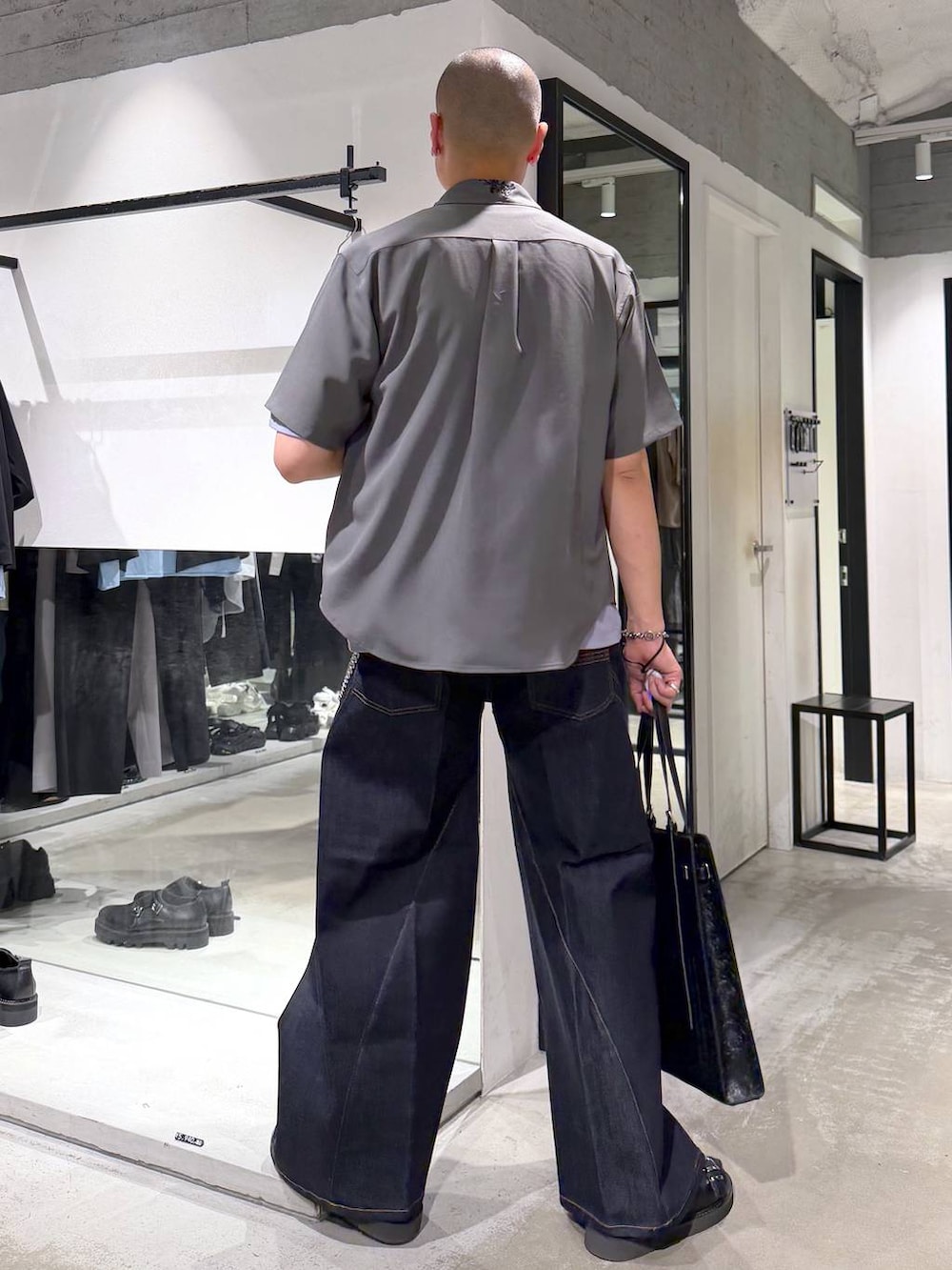 ブルー系のデニムパンツ、ブラック系のサンダル、パープル系のTシャツ/カットソーを着用したメンズの夏コーディネートの3枚目の写真