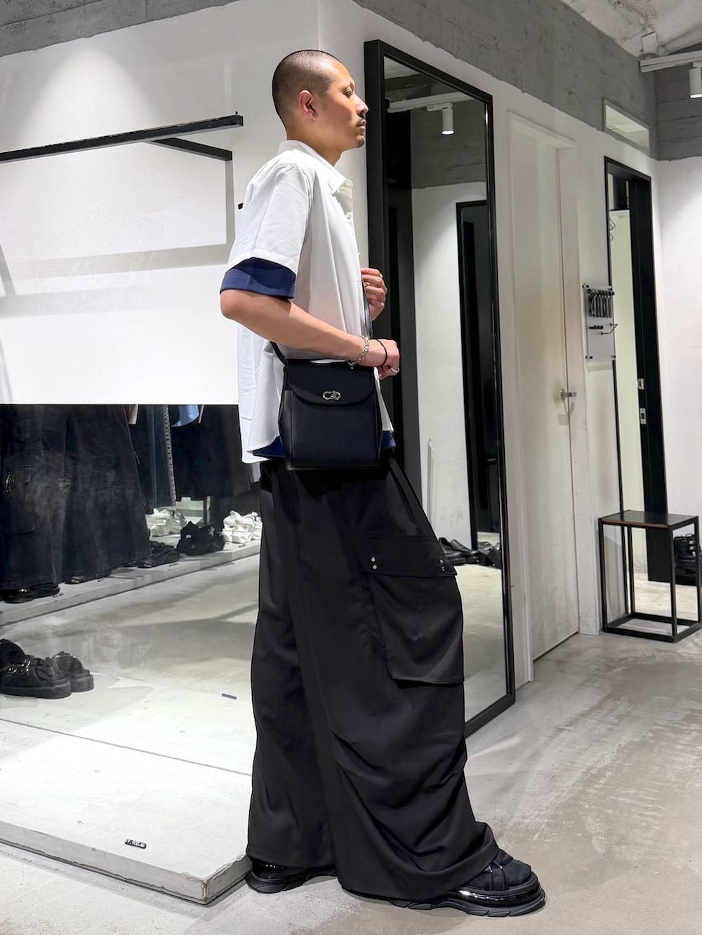 ブラック系のショルダーバッグ、ホワイト系のシャツ/ブラウス、ブラック系のカーゴパンツを着用したメンズの夏コーディネートの4枚目の写真