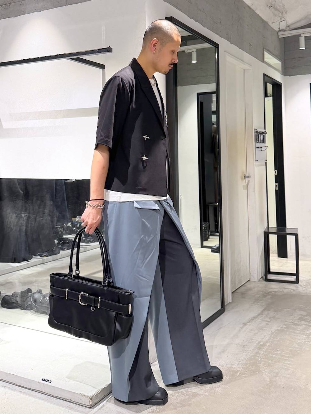 ブラック系のサンダル、ブルー系のスラックス、ホワイト系のTシャツ/カットソーを着用したメンズの夏コーディネートの4枚目の写真