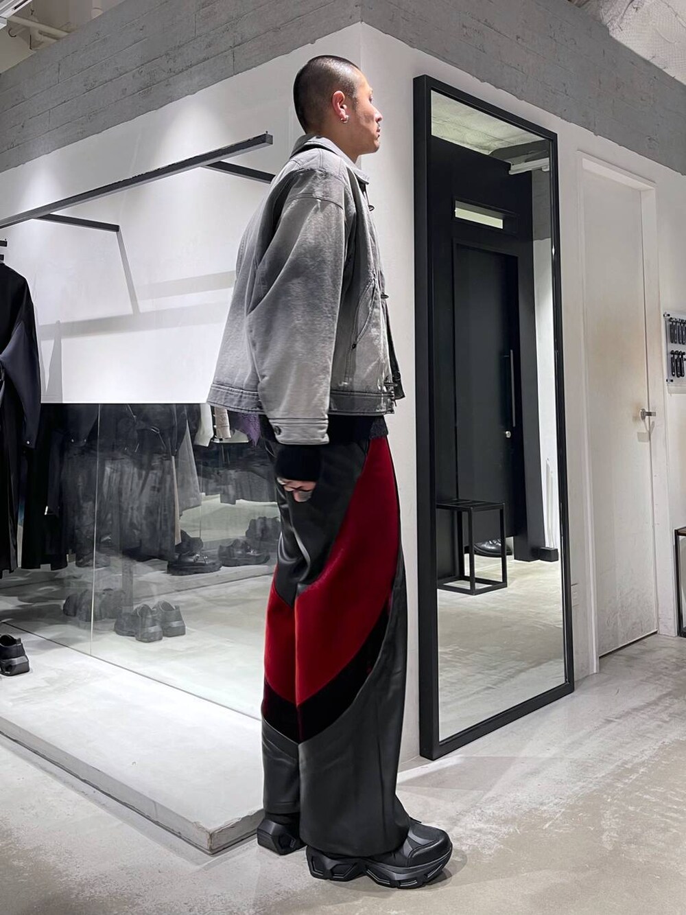 ブラック系のスニーカー、レッド系のその他パンツ、グレー系のブルゾンを着用したメンズの冬コーディネートの4枚目の写真