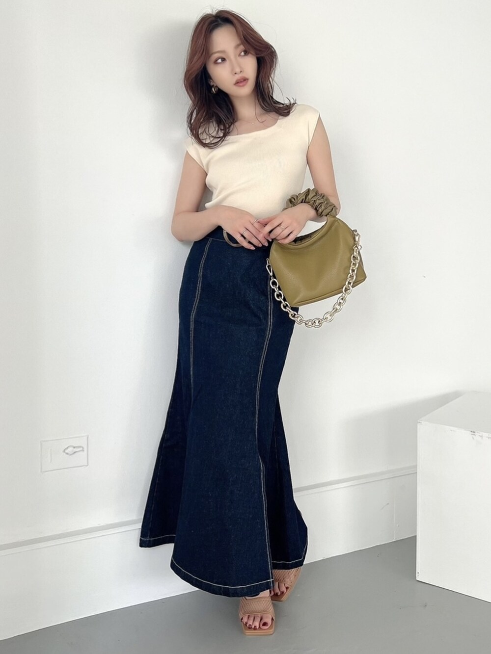 ブルー系のスカート、ホワイト系のニット/セーター、その他のサンダルを着用したレディースの夏コーディネートの3枚目の写真