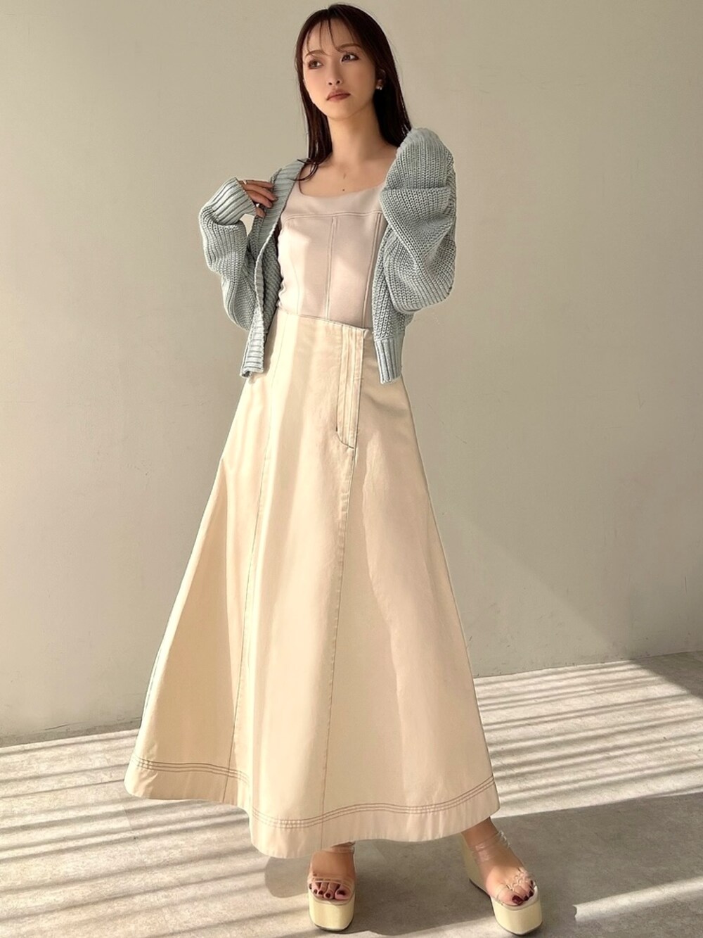 ブルー系のカーディガン/ボレロ、ベージュ系のスウェット、ホワイト系のスカートを着用したレディースの春コーディネートの3枚目の写真