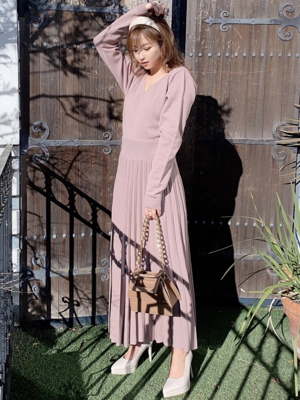 ベージュ系のワンピース、ホワイト系のパンプス、ベージュ系のカチューシャを着用したレディースの冬コーディネートの2枚目の写真