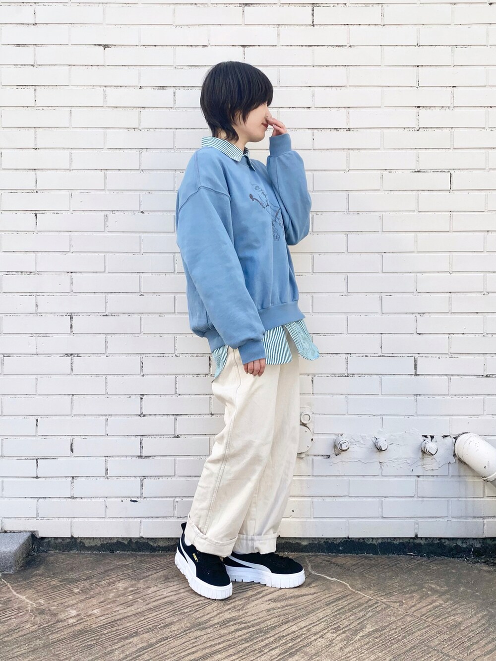 ホワイト系のデニムパンツ、グリーン系のシャツ/ブラウス、ブルー系のスウェットを着用したレディースの冬コーディネートの2枚目の写真