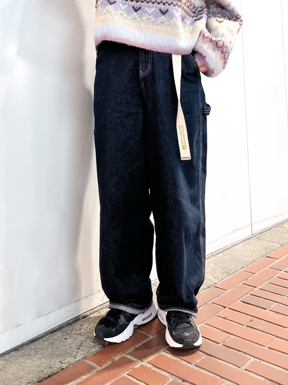 パープル系のニット/セーター、ホワイト系のTシャツ/カットソー、ホワイト系のベルトを着用したレディースの秋コーディネートの2枚目の写真